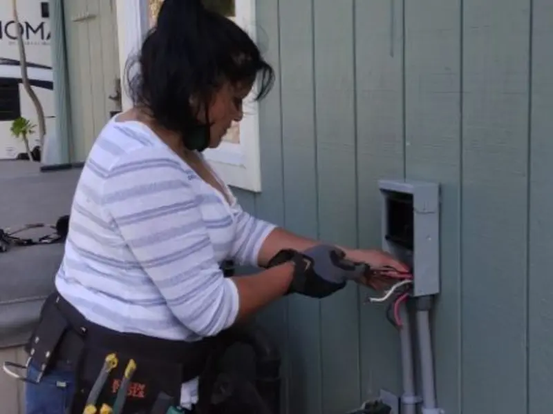 Licensed electrician wiring an exterior subpanel in Tracy