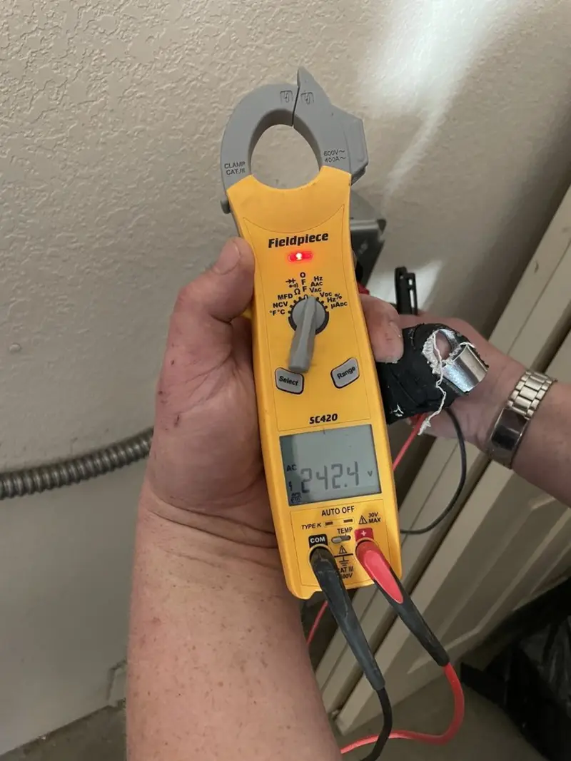 Voltage testing with clamp meter during Ceiling Fan Installation in Tracy